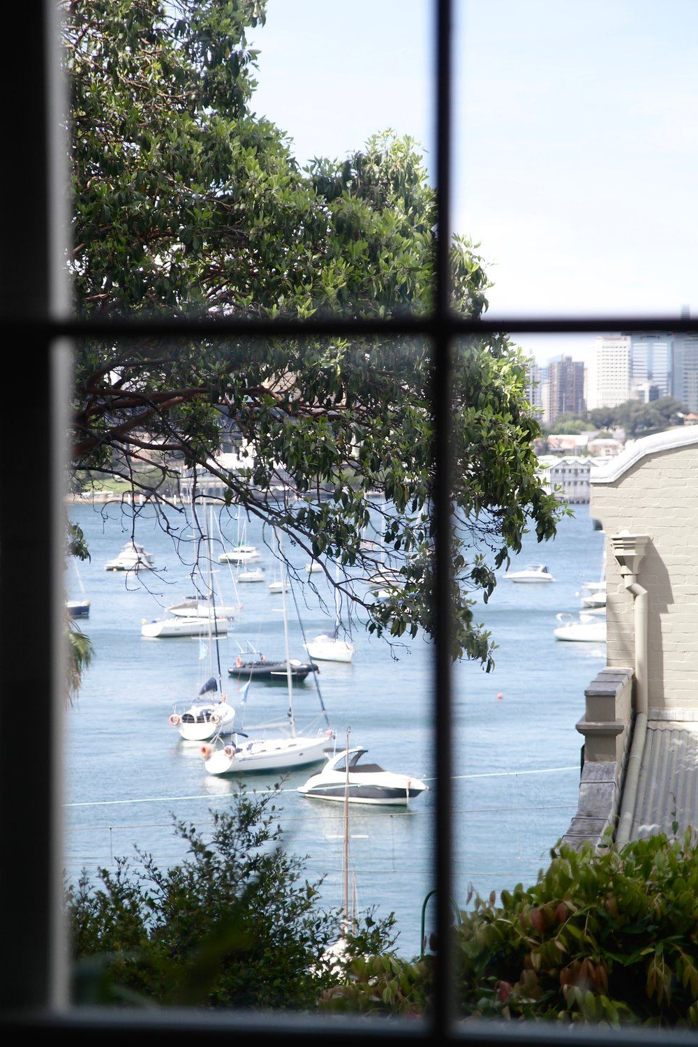 Harbour view through a restored timber sash window
