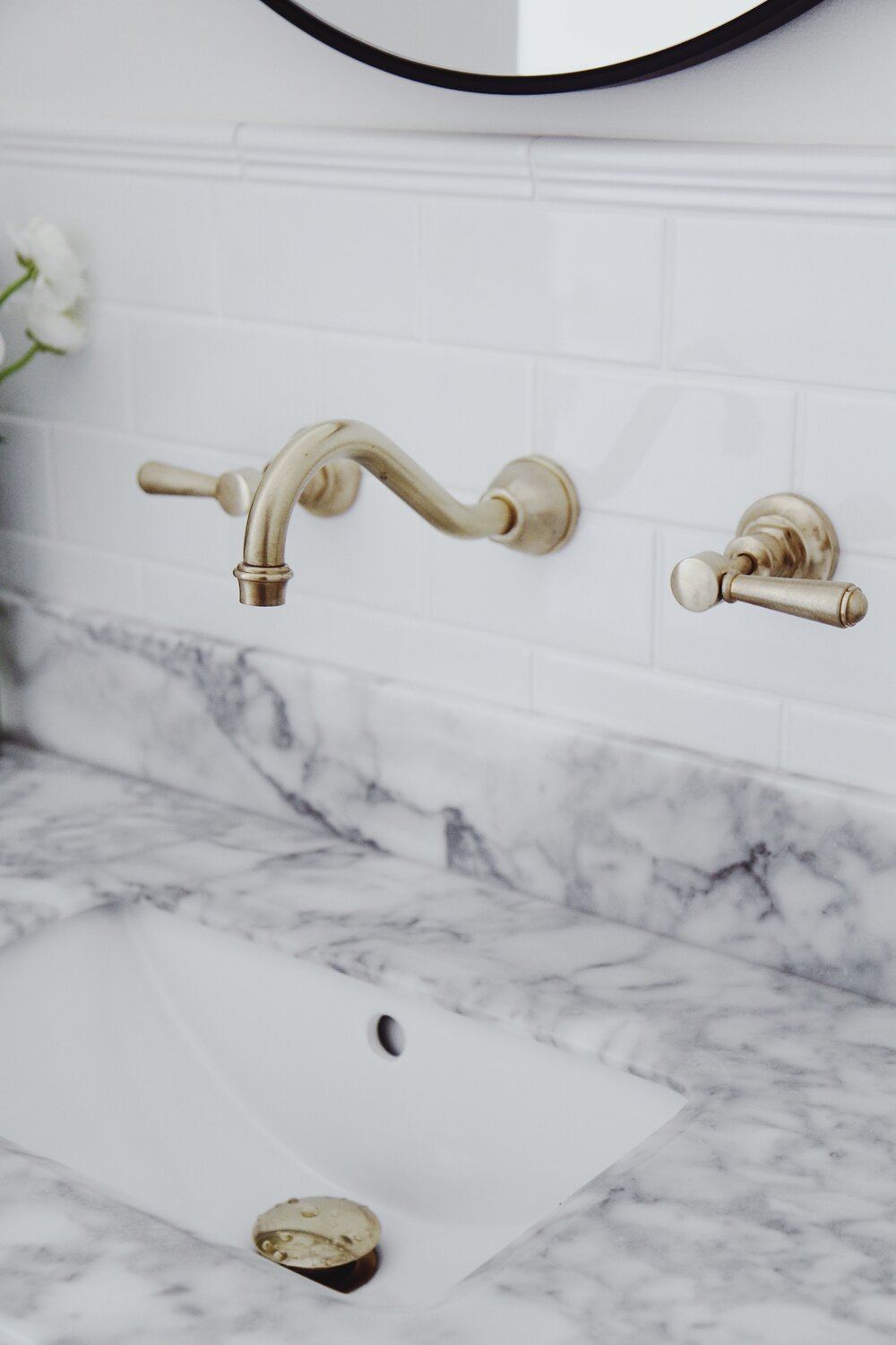 Finished bathroom vanity with marble top and brass tapware